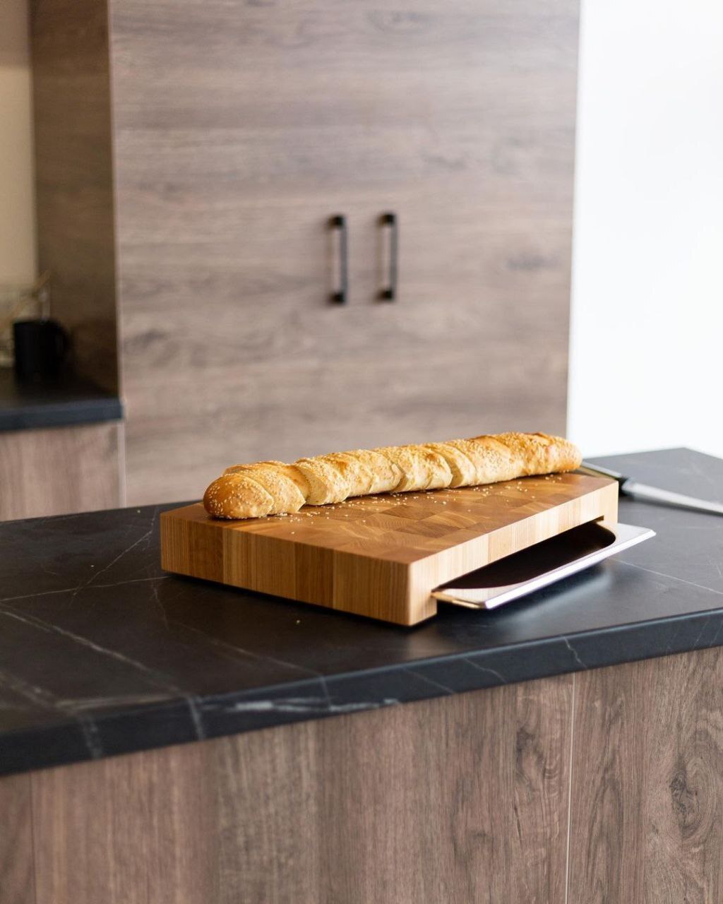 Professional wooden kitchen board made of oiled oak with stainless steel container.