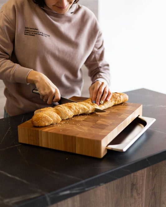 Professional wooden kitchen board made of oiled oak with stainless steel container.